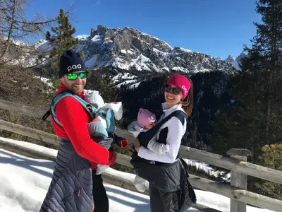 two women and a baby standing in the snow at Apartments Vaiolet in Santa Cristina in Val Gardena