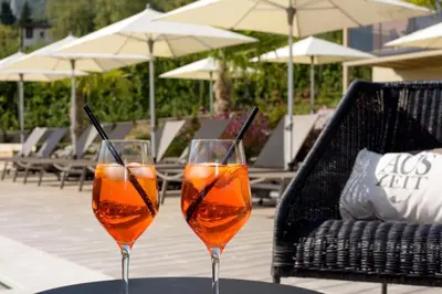 two wine glasses sitting on top of a table at Brühl Suites&Residence in Caldaro