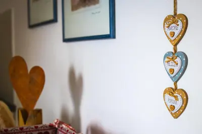 two heart ornaments hanging on a wall at Apartment CANUS - Krumas Living - Kronplatz in San Lorenzo di Sebato