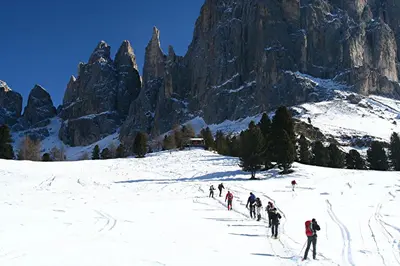 a group of people skiing down a snow covered mountain at Gasthof Edelweiss in Tires