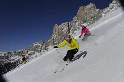 two people skiing down a snow covered mountain at Gasthof Edelweiss in Tires
