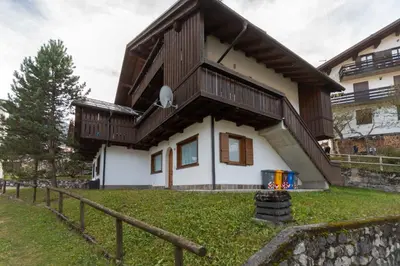 a house with a balcony on top of it at Villa Eden in Falcade