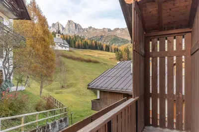 a balcony of a house with a view of the mountains at Villa Eden in Falcade