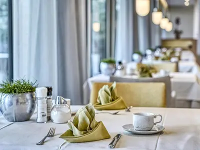 a table with a plate and a cup of coffee on it at Hotel Traubenheim in Tirolo