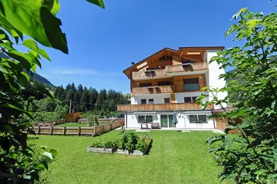 a building with a yard in front of it at Apartments Cesa Leni in Bulla