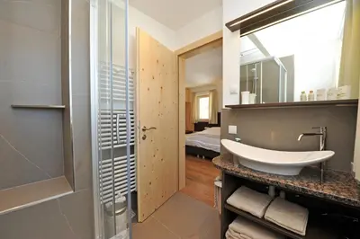 a bathroom with a sink and a mirror at Apartments Cesa Leni in Bulla