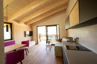 a kitchen and living room with a table and chairs at Sunnegg in Bressanone