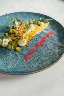 a blue plate with some food on it at Sunnegg in Bressanone