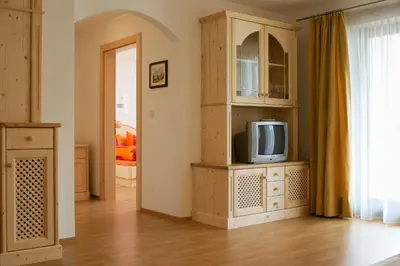 a living room with a tv on a cabinet at Sunnegg in Bressanone