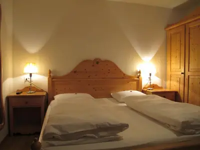 two beds in a bedroom with two pillows on them at Lüch da Grones in San Vigilio Di Marebbe