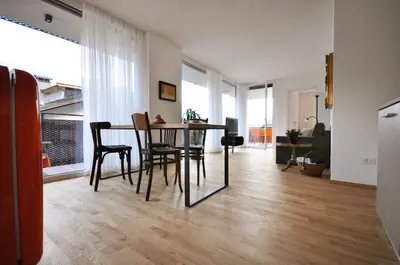 a living room with a table and chairs at Alpenchalet Apartments in Parcines
