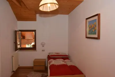 a bedroom with a bed and a ceiling at Appartamenti Vincenzo E Marcella in Campitello di Fassa