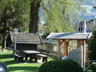 a picnic table and a bench in a park at Appartements Margit in Vipiteno