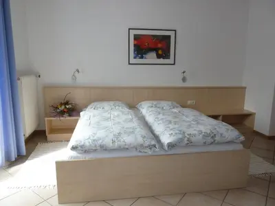 a bed with two pillows on it in a bedroom at Appartements Margit in Vipiteno