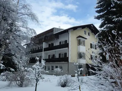 a large building in the snow with trees at Appartements Margit in Vipiteno