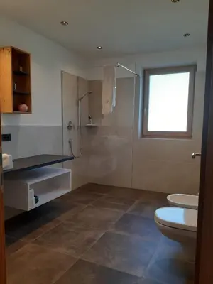 a bathroom with a shower and a toilet and a sink at Pschoalhof in Lana