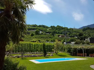 a swimming pool in the middle of a yard at Pschoalhof in Lana
