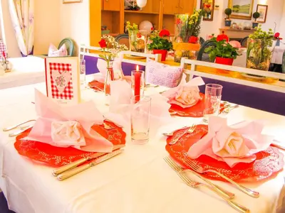 a table with two plates and napkins on it at Kröllnerhof in Lana