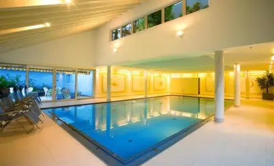 a large swimming pool in a house at Kröllnerhof in Lana