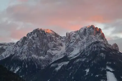 a mountain with snow on top of it at Chalet Do Costa in Pozza di Fassa