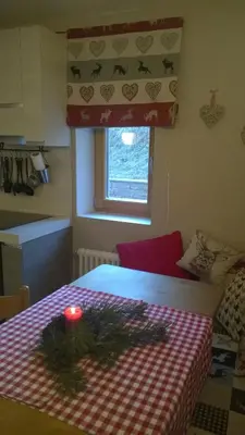 a room with a table with a candle on it at Chalet Do Costa in Pozza di Fassa