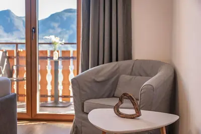 a room with a chair and a table and a window at Georgenhöhe in Lana