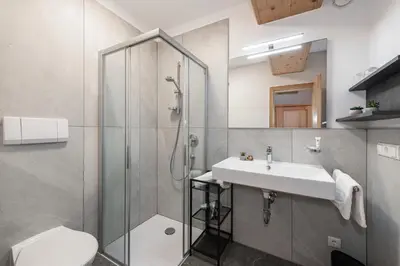 a bathroom with a sink and a shower at Georgenhöhe in Lana