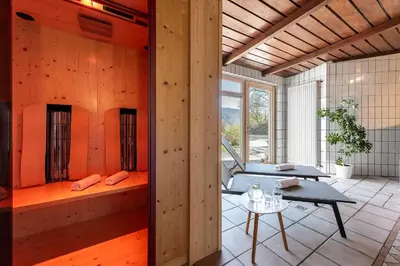 an orange room with a bench and a table at Georgenhöhe in Lana