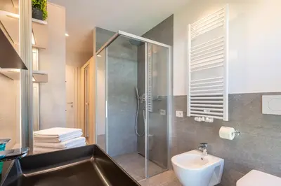 a bathroom with a glass shower and a sink at Apartment ARGENTIS Krumas-Living - Kronplatz in San Vigilio Di Marebbe