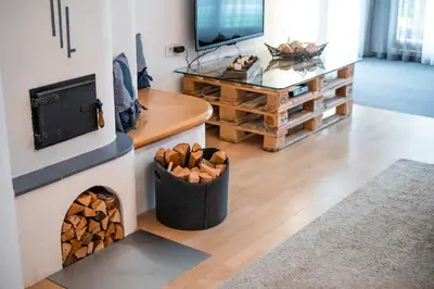 a living room with a fireplace and a tv at Apartment ARGENTIS Krumas-Living - Kronplatz in San Vigilio Di Marebbe