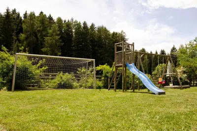 a playground with a slide and a goal at Schupferhof in Petersberg