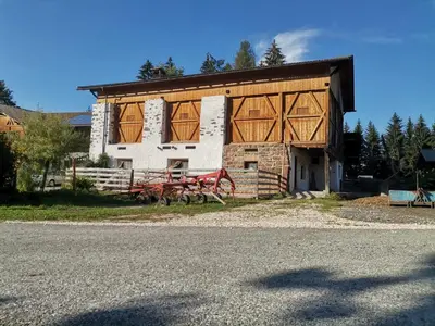 a barn with wooden doors on the side of it at Schupferhof in Petersberg