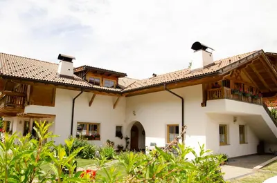 a house with a porch and a balcony at Schupferhof in Petersberg