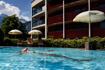 a person in a swimming pool in a hotel at ALIA appartements & wellness in Lagundo