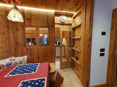 a room with a bed in a wooden room at Daniela Apartment in Cortina dʼAmpezzo