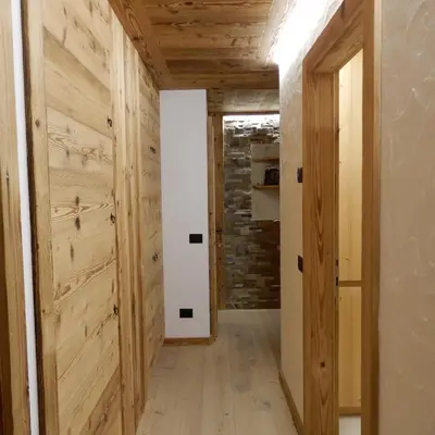 a hallway with wood paneling and a barn door at Daniela Apartment in Cortina dʼAmpezzo