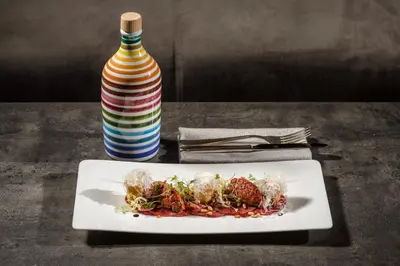 a plate of food on a table with a vase at FAYN garden retreat hotel in Lagundo