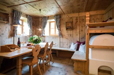 a room with a bed and a table and chairs at Chalet Hafling Leckplått in Avelengo