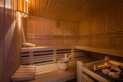 a wooden sauna with a trash can in it at Liondes Chalets in San Vigilio Di Marebbe