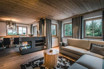 a living room with a couch and a table at Liondes Chalets in San Vigilio Di Marebbe