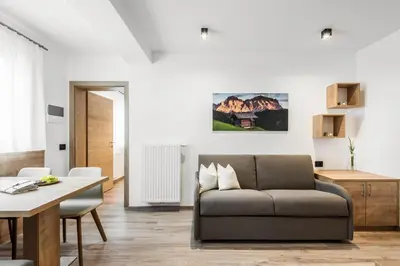 a living room with a couch and a table at Residence Mirabell in Colfosco