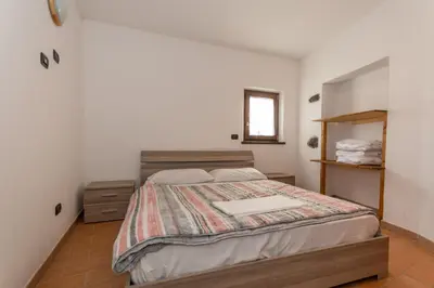 a bedroom with a bed with a book on it at Villa Simona in Falcade
