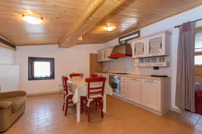a kitchen with a table and chairs in a room at Villa Simona in Falcade