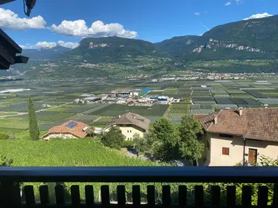 a view from a balcony of a village and mountains at Weishof in Termeno