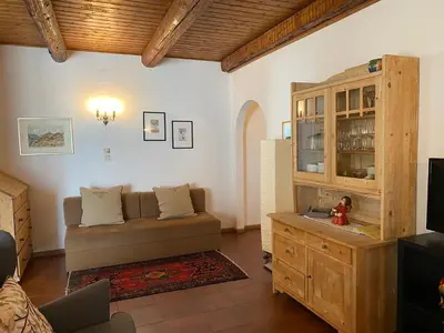 a living room with a couch and a cabinet at Weishof in Termeno