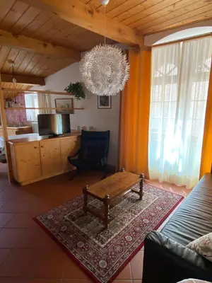 a living room with a table and a chandelier at Weishof in Termeno