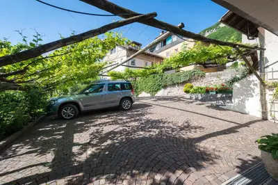a small car parked next to a building at Weishof in Termeno
