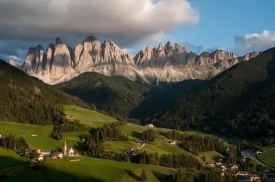 a view of a mountain range with a town in the foreground at Mes Lastei in Campitello di Fassa
