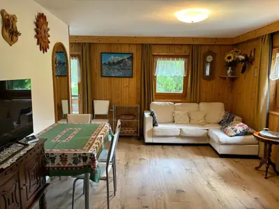 a living room with a couch and a table at Mes Lastei in Campitello di Fassa