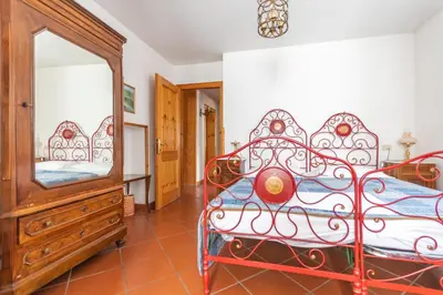 a bedroom with a bed and a dresser and a mirror at Casa Mulaz in Falcade